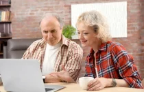 senior-couple-making-video-call-using-laptop-home